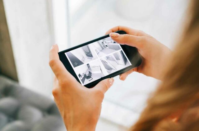 Caucasian woman monitoring security cameras on smartphone hospit