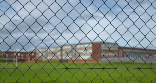 High School Building Behind A Fence SVT CCTV