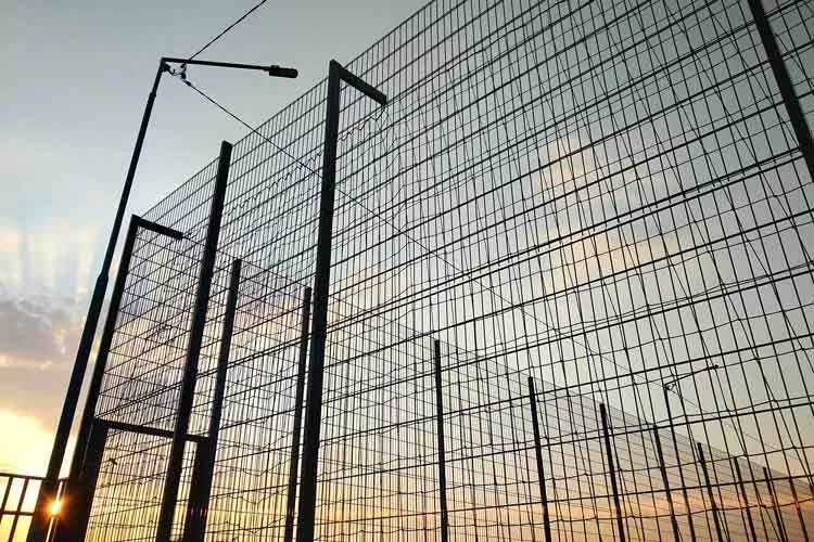 Perimeter security systems protecting a commercial facility with fencing, CCTV cameras, and intrusion detection technology